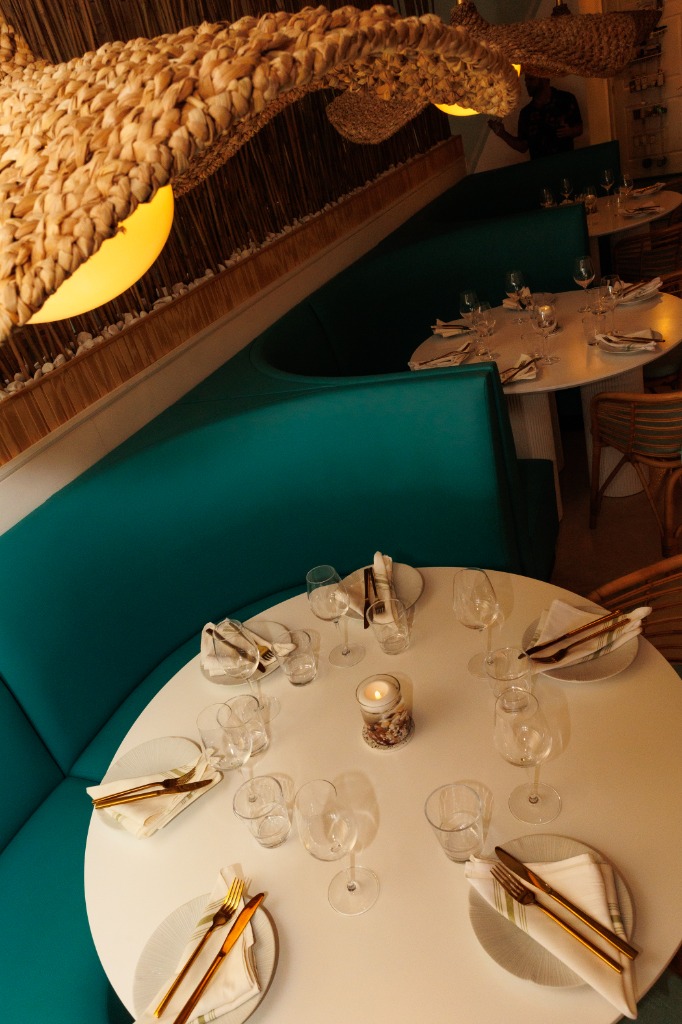 Restaurant interior atmosphere at The Salty Zebra Bistro Jupiter Florida - cozy dining room with woven lights and warm ambiance