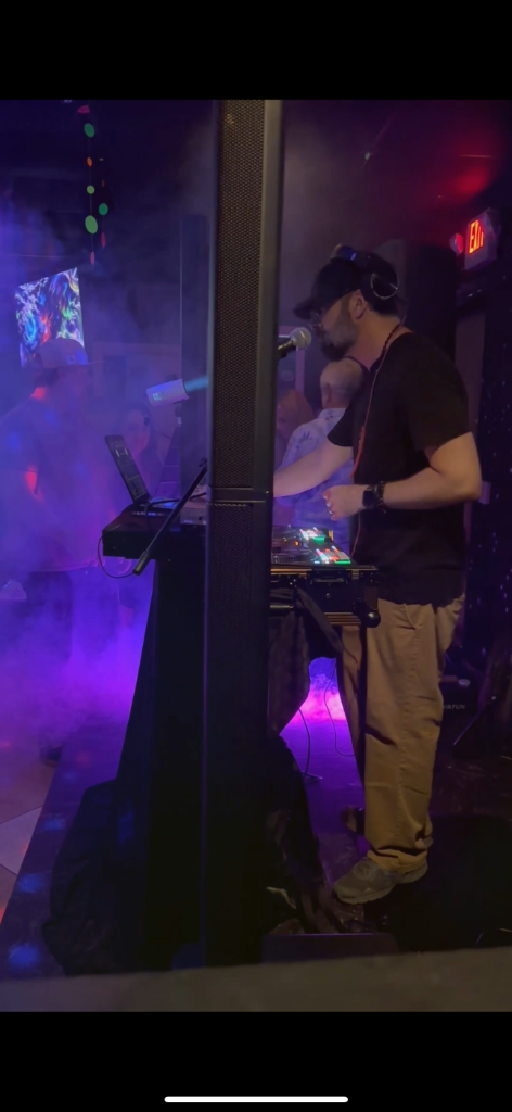 Live DJ performance at private late-night buyout at The Salty Zebra Bistro Jupiter - stage with purple lights