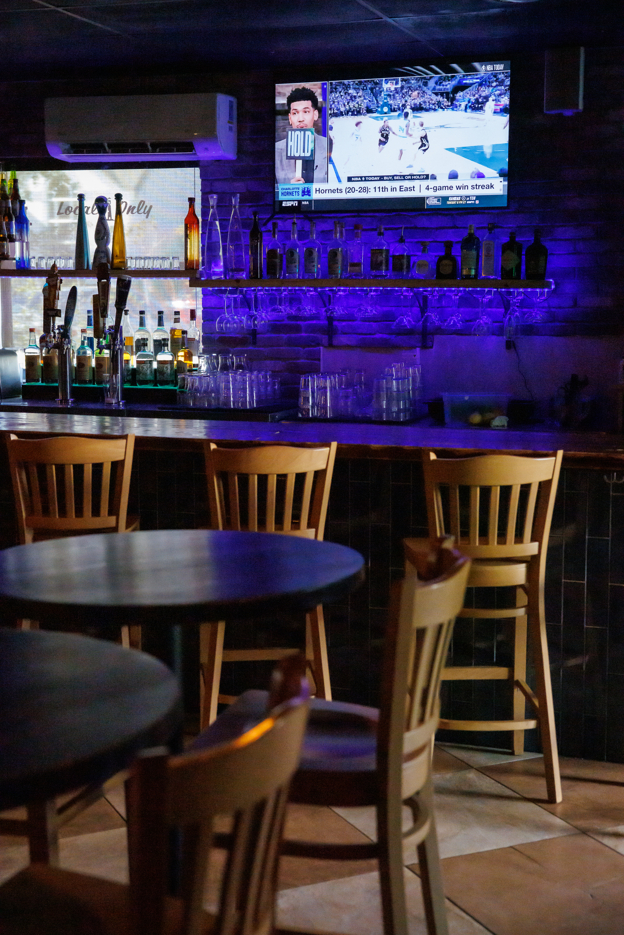 The Locals Pub bar with purple lighting in Jupiter FL