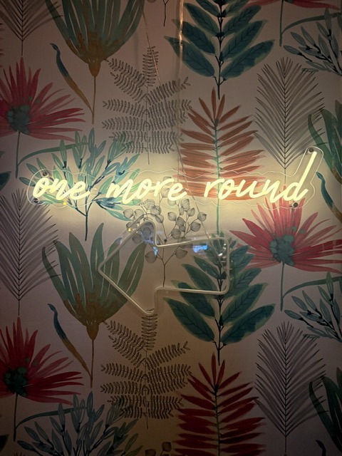 Bar atmosphere at The Salty Zebra Bistro Jupiter Florida - neon sign and late-night private event ambiance